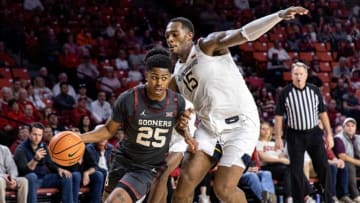 Oklahoma guard Grant Sherfield (25) works past West Virginia forward Jimmy Bell Jr. (15) in the second half during a college basketball game between the Oklahoma Sooners (OU) and the West Virginia Mountaineers at Lloyd Noble Center in Norman, Okla., Saturday, Jan. 14, 2023.ouhoops -- print1