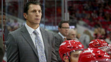 RALEIGH, NC - OCTOBER 9: Head Coach Rod Brind'Amour of the Carolina Hurricanes watches action on the ice from the bench during an NHL game against the Vancouver Canucks October 9, 2018 at PNC Arena in Raleigh, North Carolina. (Photo by Gregg Forwerck/NHLI via Getty Images)