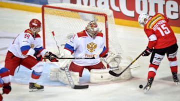 Swiss Gregory Hofmann fails to score against Russia's goalie Ilya Sorokin and Nikita Nesterov (L) during the Ice Hockey Euro Hockey Tour Karjala Cup match between Switzerland and Russia in Helsinki, Finland, on November 11, 2017. / AFP PHOTO / Lehtikuva / Timo Jaakonaho / Finland OUT (Photo credit should read TIMO JAAKONAHO/AFP via Getty Images)