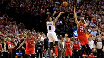 May 2, 2014; Portland, OR, USA; Portland Trail Blazers guard Damian Lillard (0) makes a three pointer at the buzzer over Houston Rockets forward Chandler Parsons (25) to win the game during the fourth quarter in game six of the first round of the 2014 NBA Playoffs at the Moda Center. Mandatory Credit: Craig Mitchelldyer-USA TODAY Sports