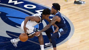 MINNEAPOLIS, MINNESOTA - DECEMBER 12: Ahmad Caver #6 of the Memphis Grizzlies defends against Ashton Hagans #22 of the Minnesota Timberwolves during the fourth quarter of the preseason game at Target Center on December 12, 2020 in Minneapolis, Minnesota. The Grizzlies defeated the Timberwolves 107-105. NOTE TO USER: User expressly acknowledges and agrees that, by downloading and or using this Photograph, user is consenting to the terms and conditions of the Getty Images License Agreement. (Photo by Hannah Foslien/Getty Images)