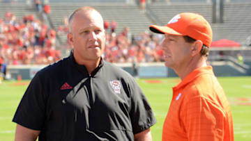 Sep 25, 2021; Raleigh, North Carolina, USA; North Carolina State Wolfpack head coach Dave Doeren (left) chats with Clemson Tigers head coach Dabo Swinney prior to a game at Carter-Finley Stadium. Mandatory Credit: Rob Kinnan-USA TODAY Sports
