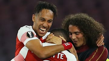 Arsenal's French striker Alexandre Lacazette (C) celebrates with Arsenal's Gabonese striker Pierre-Emerick Aubameyang (L) and Arsenal's French midfielder Matteo Guendouzi after opening the scoring during the UEFA Europa League quarter-final second leg football match Napoli vs Arsenal on April 18, 2019 at the San Paolo stadium in Naples. (Photo by Carlo Hermann / AFP) (Photo credit should read CARLO HERMANN/AFP/Getty Images)