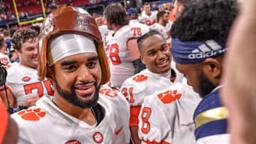 Clemson quarterback D.J. Uiagalelei (5) and Georgia Tech offensive lineman Paul Tchio (57) smile meeting each other after the game at the Mercedes-Benz Stadium in Atlanta, Georgia Monday, September 5, 2022. Clemson won 41-10. Tchio, a former Clemson lineman, entered the transfer portal before going to Georgia Tech.Ncaa Fb Clemson At Georgia Tech