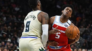 MILWAUKEE, WISCONSIN - FEBRUARY 10: De'Aaron Fox #5 of the Sacramento Kings is fouled by Wesley Matthews #9 of the Milwaukee Bucks during the second half at Fiserv Forum on February 10, 2020 in Milwaukee, Wisconsin. NOTE TO USER: User expressly acknowledges and agrees that, by downloading and or using this photograph, User is consenting to the terms and conditions of the Getty Images License Agreement. (Photo by Stacy Revere/Getty Images)