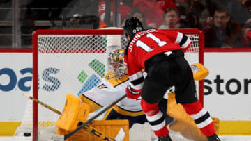 Juuse Saros #74 of the Nashville Predators stops a shot by Andreas Johnsson #11 of the New Jersey Devils during the first period at Prudential Center on December 10, 2021 in Newark, New Jersey. (Photo by Elsa/Getty Images)