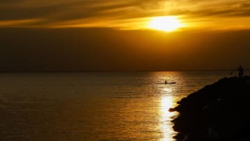 MELBOURNE, VICTORIA, AUSTRALIA - 2023/04/26: A man in a kayak paddles across the sunset at Middle Brighton Beach in Melbourne. (Photo by George Hitchens/SOPA Images/LightRocket via Getty Images)