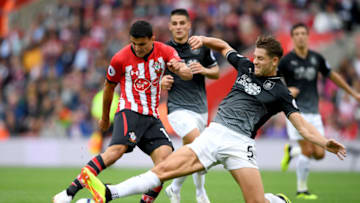 SOUTHAMPTON, ENGLAND - AUGUST 12: Mohamed Elyounoussi of Southampton shoots under pressure from James Tarkowski of Burnley during the Premier League match between Southampton FC and Burnley FC at St Mary's Stadium on August 12, 2018 in Southampton, United Kingdom. (Photo by Mike Hewitt/Getty Images)