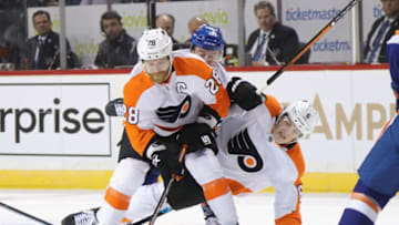 NEW YORK, NEW YORK - FEBRUARY 11: Travis Sanheim #6 of the Philadelphia Flyers is checked into Claude Giroux #28 during the first period against the New York Islanders at the Barclays Center on February 11, 2020 in the Brooklyn borough of New York City. (Photo by Bruce Bennett/Getty Images)