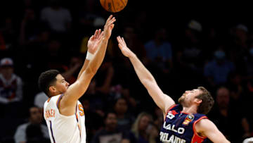 PHOENIX, ARIZONA - OCTOBER 02: Devin Booker #1 of the Phoenix Suns shoots over Mitch McCarron #10 of the Adelaide 36ers during the first half at Footprint Center on October 02, 2022 in Phoenix, Arizona. NOTE TO USER: User expressly acknowledges and agrees that, by downloading and or using this photograph, User is consenting to the terms and conditions of the Getty Images License Agreement. (Photo by Chris Coduto/Getty Images)