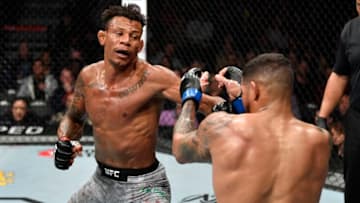 LAS VEGAS, NEVADA - MARCH 07: Alex 'Cowboy' Oliveira of Brazil punches Max Griffin in their welterweight fight during the UFC 248 event at T-Mobile Arena on March 07, 2020 in Las Vegas, Nevada. (Photo by Jeff Bottari/Zuffa LLC)
