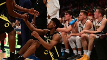 NEW YORK, NEW YORK - NOVEMBER 15: A teammate helps Victor Bailey Jr. #10 of the Oregon Ducks off the ground during the first half of the game against Iowa Hawkeyes during the 2k Empire Classic at Madison Square Garden on November 15, 2018 in New York City. (Photo by Sarah Stier/Getty Images)