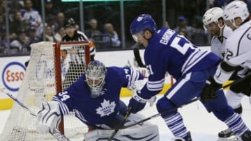 Dec 14, 2014; Toronto, Ontario, CAN; Toronto Maple Leafs defenceman Jake Gardiner (51) and Toronto Maple Leafs goaltender James Reimer (34) go to cover up a loose puck against the Los Angeles Kings during the first period at the Air Canada Centre. Mandatory Credit: John E. Sokolowski-USA TODAY Sports