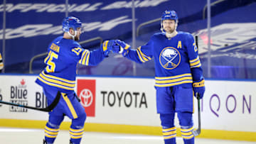 Apr 23, 2021; Buffalo, New York, USA; Buffalo Sabres center Sam Reinhart (23) celebrates his third goal of the game with center Riley Sheahan (15) during the third period against the Boston Bruins at KeyBank Center. Mandatory Credit: Timothy T. Ludwig-USA TODAY Sports