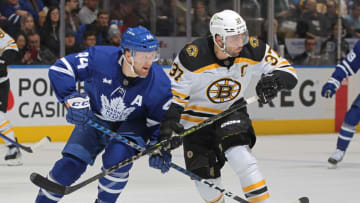 Patrice Bergeron #37 of the Boston Bruins battles against Morgan Rielly #44 of the Toronto Maple Leafs (Photo by Claus Andersen/Getty Images)