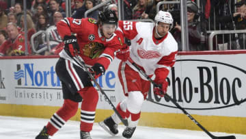 CHICAGO, IL - FEBRUARY 10: Dylan Strome #17 of the Chicago Blackhawks and Niklas Kronwall #55 of the Detroit Red Wings chase the puck in the first period at the United Center on February 10, 2019 in Chicago, Illinois. (Photo by Bill Smith/NHLI via Getty Images)