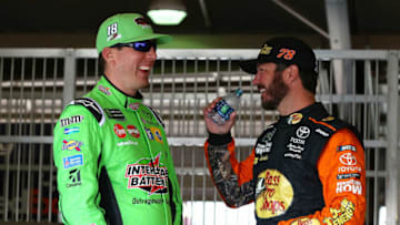 FONTANA, CA - MARCH 16: Kyle Busch, driver of the #18 Interstate Batteries Toyota, talks with Martin Truex Jr., driver of the #78 Bass Pro Shops/5-hour ENERGY Toyota, during practice for the Monster Energy NASCAR Cup Series Auto Club 400 at Auto Club Speedway on March 16, 2018 in Fontana, California. (Photo by Sarah Crabill/Getty Images)