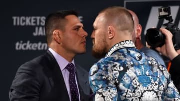 LAS VEGAS, NV - JANUARY 20: Rafael dos Anjos of Brazil (L) and Conor McGregor of Ireland (R) face off during the UFC 197 on-sale press conference event inside MGM Grand Hotel