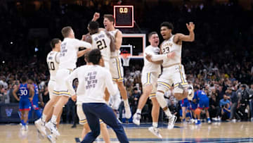 PHILADELPHIA, PA - DECEMBER 21: Cole Swider #10, Dhamir Cosby-Roundtree #21, Collin Gillespie #2, and Jermaine Samuels #23 of the Villanova Wildcats celebrate with their teammates after defeating the Kansas Jayhawks at the Wells Fargo Center on December 21, 2019 in Philadelphia, Pennsylvania. The Villanova Wildcats defeated the Kansas Jayhawks 56-55. (Photo by Mitchell Leff/Getty Images)