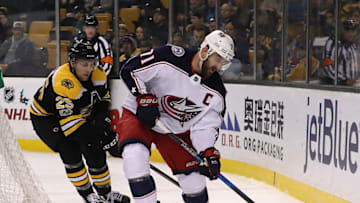 BOSTON - DECEMBER 18: Boston Bruins defenseman Brandon Carlo (25) puts defensive pressure on Columbus Blue Jackets left wing Nick Foligno (71) during the third period. The Boston Bruins host the Columbus Blue Jackets in a regular season NHL hockey game at TD Garden in Boston on Dec. 18, 2017. (Photo by Matthew J. Lee/The Boston Globe via Getty Images)