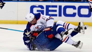 Jan 19, 2016; Tampa, FL, USA; Edmonton Oilers right wing Nail Yakupov (10) falls on Tampa Bay Lightning defenseman Braydon Coburn (55) during the first period at Amalie Arena. Mandatory Credit: Kim Klement-USA TODAY Sports