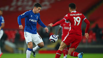 LIVERPOOL, ENGLAND - FEBRUARY 20: James Rodriguez of Everton and Ozan Kabak of Liverpool during the Premier League match between Liverpool and Everton at Anfield on February 20, 2021 in Liverpool, United Kingdom. Sporting stadiums around the UK remain under strict restrictions due to the Coronavirus Pandemic as Government social distancing laws prohibit fans inside venues resulting in games being played behind closed doors. (Photo by Robbie Jay Barratt - AMA/Getty Images)
