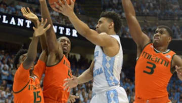 Feb 20, 2016; Chapel Hill, NC, USA; North Carolina Tar Heels guard Joel Berry II (2) shoots in front of Miami Hurricanes center Ebuka Izundu (15) guard Davon Reed (5) and forward Anthony Lawrence Jr. (3) during the second half at Dean E. Smith Center. North Carolina won 96-71. Mandatory Credit: Rob Kinnan-USA TODAY Sports