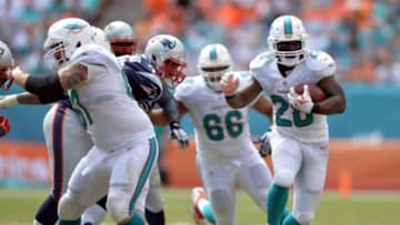 Sep 7, 2014; Miami Gardens, FL, USA; Miami Dolphins running back Knowshon Moreno (28) runs against the New England Patriots during the second half at Sun Life Stadium. The Dolphins won 33-20. Mandatory Credit: Steve Mitchell-USA TODAY Sports