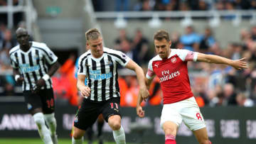 NEWCASTLE UPON TYNE, ENGLAND - SEPTEMBER 15: Aaron Ramsey of Arsenal is challenged by Matt Ritchie of Newcastle United during the Premier League match between Newcastle United and Arsenal FC at St. James Park on September 15, 2018 in Newcastle upon Tyne, United Kingdom. (Photo by Alex Livesey/Getty Images)