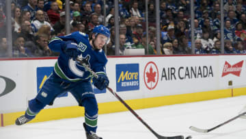 Feb 12, 2020; Vancouver, British Columbia, CAN; Vancouver Canucks defenseman Quinn Hughes (43) clears the puck against the Chicago Blackhawks in the second period at Rogers Arena. Mandatory Credit: Bob Frid-USA TODAY Sports