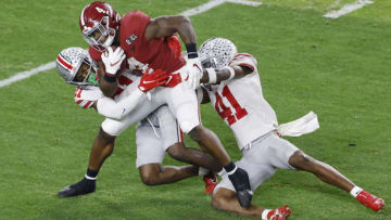 MIAMI GARDENS, FLORIDA - JANUARY 11: Joshua McMillon #40 of the Alabama Crimson Tide is wrapped up by Josh Proctor #41 of the Ohio State Buckeyes during the third quarter of the College Football Playoff National Championship game at Hard Rock Stadium on January 11, 2021 in Miami Gardens, Florida. (Photo by Michael Reaves/Getty Images)