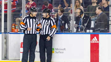 NEW YORK, NY - OCTOBER 08: Referees Wes McCauley #4 and Justin StPierre #12 discuss a reviewed play, in which the first of 2 Canadiens goals were over turned during the first period of a regular season NHL game between the Montreal Canadiens and the New York Rangers on October 08, 2017, at Madison Square Garden in New York, NY. (Photo by David Hahn/Icon Sportswire via Getty Images)