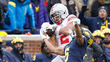 Nov 27, 2021; Ann Arbor, Michigan, USA; Ohio State Buckeyes wide receiver Chris Olave (2) makes a reception over Michigan Wolverines defensive back DJ Turner (5) at Michigan Stadium. Mandatory Credit: Rick Osentoski-USA TODAY Sports