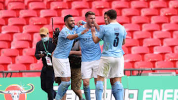 LONDON, ENGLAND - APRIL 25: Aymeric Laporte of Manchester City celebrates with Riyad Mahrez and Ruben Dias after scoring their side's first goal during the Carabao Cup Final between Manchester City and Tottenham Hotspur at Wembley Stadium on April 25, 2021 in London, England. 8,000 fans are due to watch the game at Wembley, the most at an outdoor sporting event in the UK since the coronavirus pandemic started in March, 2020. Each team has been given an allocation of 2,000 with the remaining tickets split between local residents and NHS staff. (Photo by Clive Rose/Getty Images)
