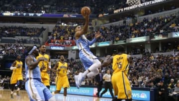 Nov 14, 2014; Indianapolis, IN, USA; Denver Nuggets guard Gary Harris (14) lays the ball in against Indiana Pacers guard Donald Sloan (15) at Bankers Life Fieldhouse. Mandatory Credit: Brian Spurlock-USA TODAY Sports