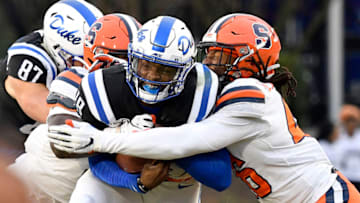 DURHAM, NORTH CAROLINA - NOVEMBER 16: Lakiem Williams #46 of the Syracuse Orange tackles Quentin Harris #18 of the Duke Blue Devils during the first half of their game at Wallace Wade Stadium on November 16, 2019 in Durham, North Carolina. (Photo by Grant Halverson/Getty Images)