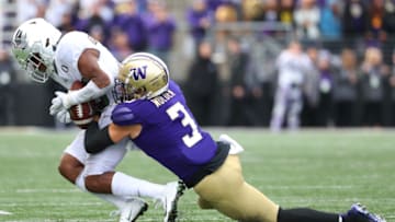 SEATTLE, WASHINGTON - OCTOBER 19: Jaylon Redd #30 of the Oregon Ducks completes a pass against Elijah Molden #3 of the Washington Huskies in the third quarter during their game at Husky Stadium on October 19, 2019 in Seattle, Washington. (Photo by Abbie Parr/Getty Images)
