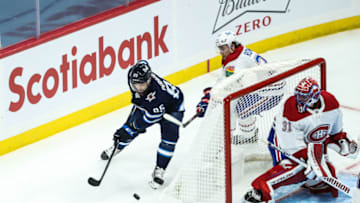 Mar 15, 2021; Winnipeg, Manitoba, CAN; Winnipeg Jets forward Matthieu Perreault (85) skates away from Montreal Canadiens defenseman Alexander Romanov (27) during the third period at Bell MTS Place. Mandatory Credit: Terrence Lee-USA TODAY Sports
