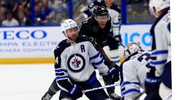TAMPA, FLORIDA - APRIL 16: Connor Hellebuyck #37 of the Winnipeg Jets stops a shot from Brayden Point #21 of the Tampa Bay Lightning in the second period during a game at Amalie Arena on April 16, 2022 in Tampa, Florida. (Photo by Mike Ehrmann/Getty Images)