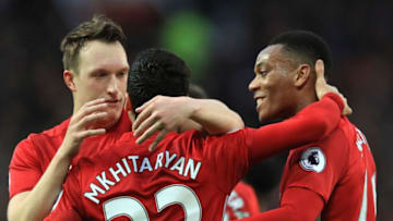 MANCHESTER, ENGLAND - DECEMBER 11: Henrikh Mkhitaryan (C) of Manchester United celebrates scoring the opening goal with his team mates Phil Jones (L) and Anthony Martial (R) during the Premier League match between Manchester United and Tottenham Hotspur at Old Trafford on December 11, 2016 in Manchester, England. (Photo by Richard Heathcote/Getty Images)
