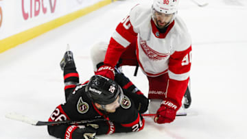 OTTAWA, CANADA - OCTOBER 21: Joe Veleno #90 of the Detroit Red Wings gets tangled up with Erik Brannstrom #26 of the Ottawa Senators in the second period at Canadian Tire Centre on October 21, 2023 in Ottawa, Ontario, Canada. (Photo by Chris Tanouye/Freestyle Photography/Getty Images)