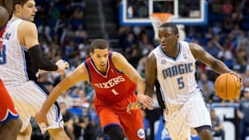 Mar 2, 2014; Orlando, FL, USA; Orlando Magic shooting guard Victor Oladipo (5) drives with the ball as Philadelphia 76ers point guard Michael Carter-Williams (1) defends during the second half of the game at the Amway Center. Orlando defeated Philadelphia 92-81. Mandatory Credit: Rob Foldy-USA TODAY Sports