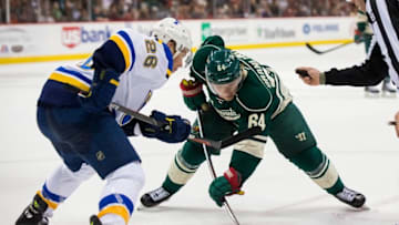 Mar 6, 2016; Saint Paul, MN, USA; Minnesota Wild forward Mikael Granlund (64) and St. Louis Blues forward Paul Stastny (26) take the faceoff in the second period at Xcel Energy Center. The St. Louis Blues beat the Minnesota Wild 4-2. Mandatory Credit: Brad Rempel-USA TODAY Sports