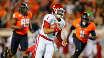 STILLWATER, OK - NOVEMBER 30: Quarterback Jalen Hurts #1 of the Oklahoma Sooners breaks free for a 28-yard touchdown run against defensive end Tyler Lacy #89 and linebacker Amen Ogbongbemiga #11 of the Oklahoma State Cowboys in the first quarter on November 30, 2019 at Boone Pickens Stadium in Stillwater, Oklahoma. (Photo by Brian Bahr/Getty Images)