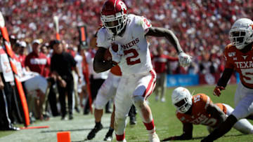 Oct 12, 2019; Dallas, TX, USA; Oklahoma Sooners wide receiver CeeDee Lamb (2) runs over Texas Longhorns defensive back Chris Brown (15) and scores a touchdown during the second half at the Cotton Bowl. Mandatory Credit: Kevin Jairaj-USA TODAY Sports