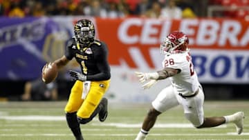 Dec 17, 2016; Atlanta, GA, USA; Grambling State Tigers quarterback Devante Kincade (1) avoids North Carolina Central Eagles defensive lineman Kawuan Cox (28) in the second quarter at the Georgia Dome. Mandatory Credit: Brett Davis-USA TODAY Sports