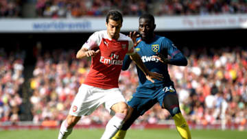 LONDON, ENGLAND - AUGUST 25: Henrikh Mkhitaryan of Arsenal is challenged by Arthur Masuaku of West Ham United during the Premier League match between Arsenal FC and West Ham United at Emirates Stadium on August 25, 2018 in London, United Kingdom. (Photo by Michael Regan/Getty Images)