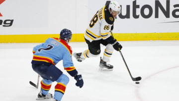 Nov 23, 2022; Sunrise, Florida, USA; Boston Bruins right wing David Pastrnak (88) moves the puck as Florida Panthers defenseman Radko Gudas (7) defends during the third period at FLA Live Arena. Mandatory Credit: Sam Navarro-USA TODAY Sports