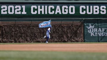 Apr 1, 2021; Chicago, Illinois, USA; Chicago Cubs right fielder Jason Heyward (22) arrives on the field with a Chicago city flag before an MLB game against the Pittsburgh Pirates at Wrigley Field. Mandatory Credit: Kamil Krzaczynski-USA TODAY Sports