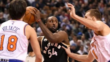 Jan 28, 2016; Toronto, Ontario, CAN; Toronto Raptors forward Patrick Patterson (54) looks to make a pass between New York Knicks guard Sasha Vujacic (18) and forward Lou Amundson (17) during the second half of the Raptors 103-93 win at Air Canada Centre. Mandatory Credit: Dan Hamilton-USA TODAY Sports